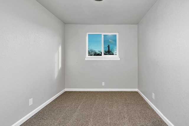 carpeted spare room with baseboards