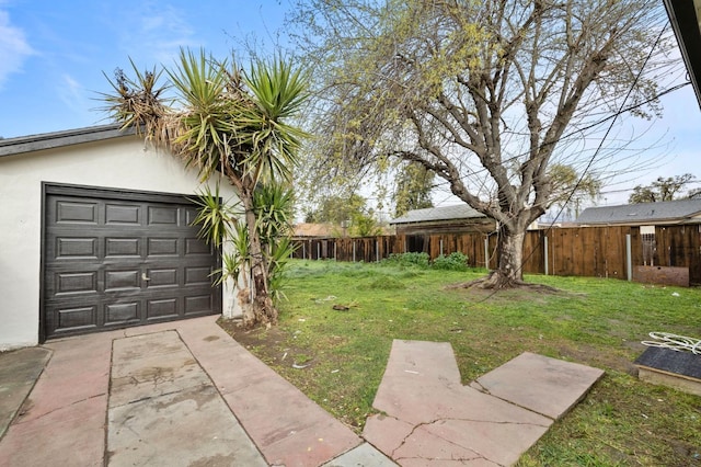 view of yard with driveway and fence