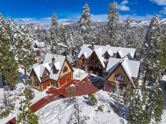 snowy aerial view with a mountain view