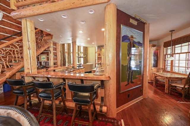 bar featuring indoor wet bar, hardwood / wood-style flooring, and recessed lighting