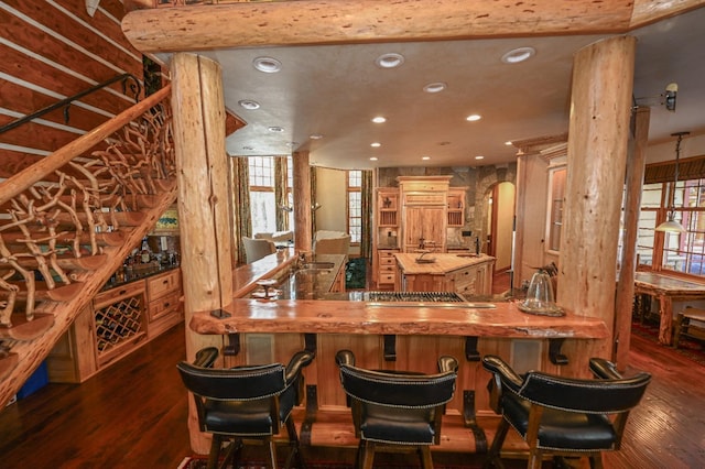 bar featuring stainless steel gas stovetop, decorative columns, recessed lighting, wood finished floors, and arched walkways