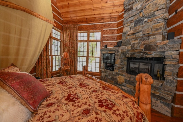 bedroom featuring wood finished floors, lofted ceiling, wooden ceiling, and a fireplace