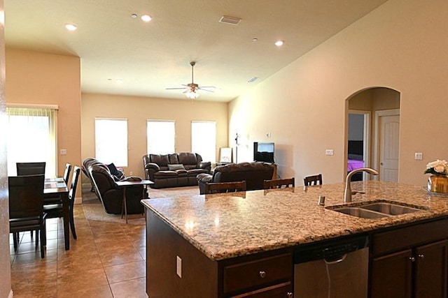 kitchen featuring visible vents, dark brown cabinets, dishwasher, a ceiling fan, and a sink