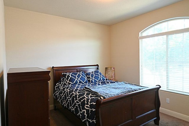 carpeted bedroom with baseboards