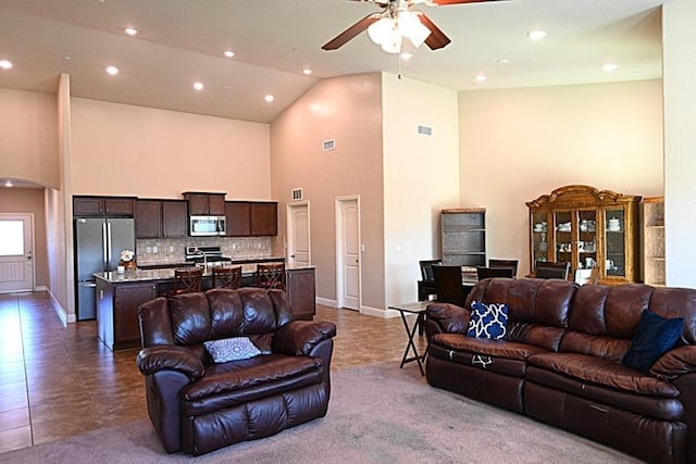 living area with baseboards, visible vents, high vaulted ceiling, recessed lighting, and ceiling fan