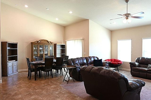 living room with recessed lighting, baseboards, a high ceiling, and ceiling fan