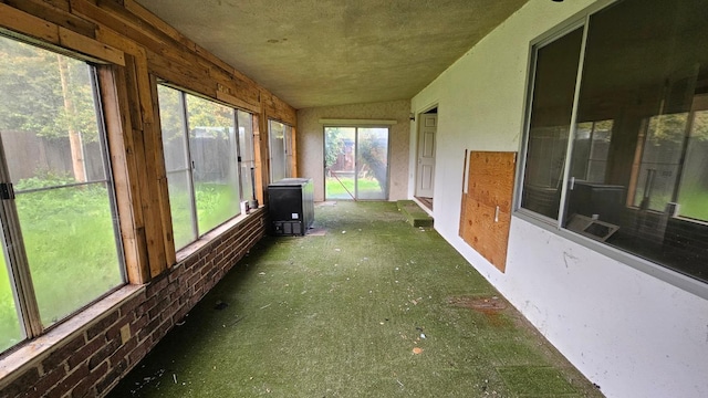 unfurnished sunroom featuring vaulted ceiling