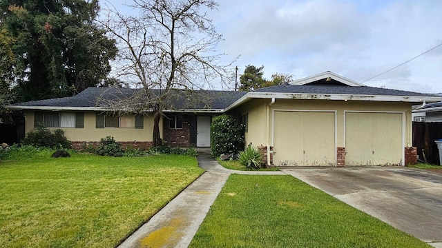 single story home featuring a front yard, stucco siding, concrete driveway, a garage, and brick siding