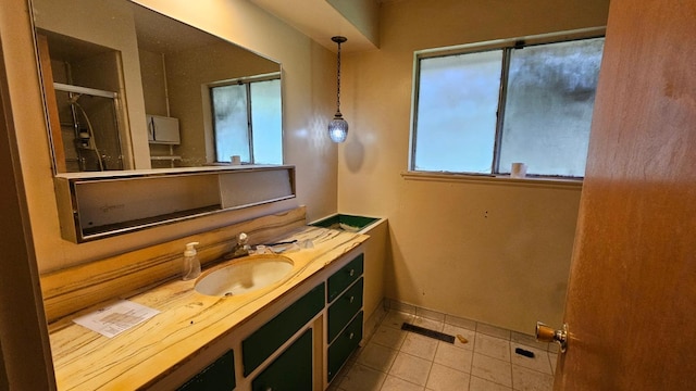 bathroom with an enclosed shower, baseboards, vanity, and tile patterned flooring