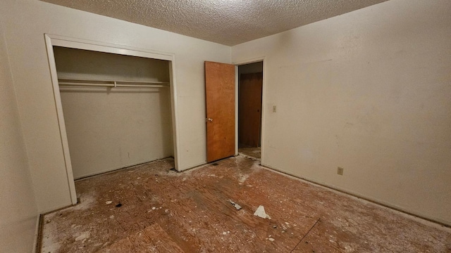 unfurnished bedroom featuring a closet and a textured ceiling