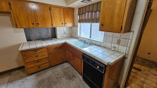 kitchen with baseboards, dishwasher, decorative backsplash, brown cabinetry, and a sink