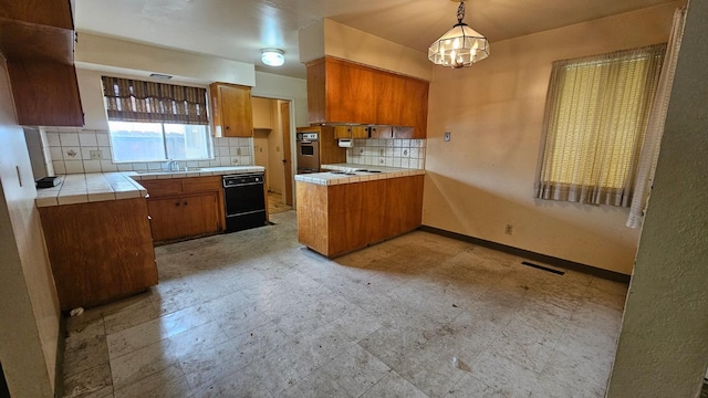 kitchen featuring brown cabinetry, tile countertops, dishwasher, and stainless steel oven