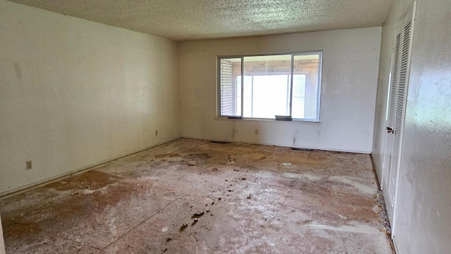 empty room with a textured ceiling