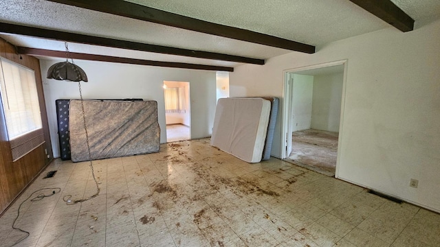 interior space featuring tile patterned floors, visible vents, and a textured ceiling