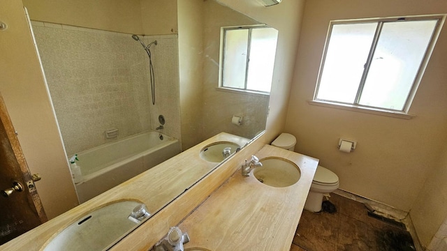 full bath with vanity, toilet, and  shower combination