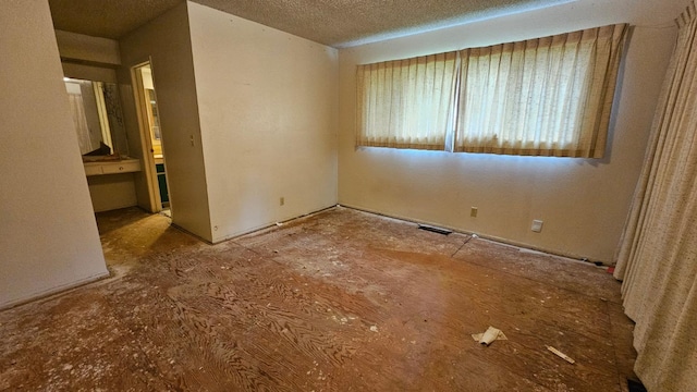 spare room with visible vents and a textured ceiling