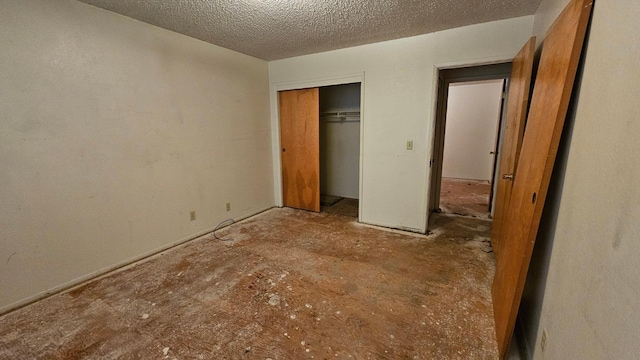 unfurnished bedroom with a closet and a textured ceiling