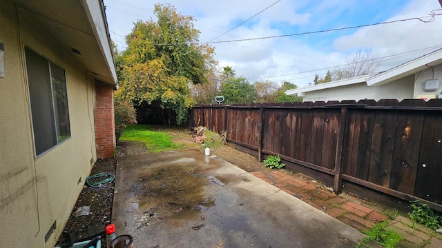 view of patio featuring fence