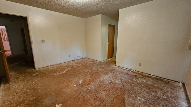 spare room featuring a textured ceiling