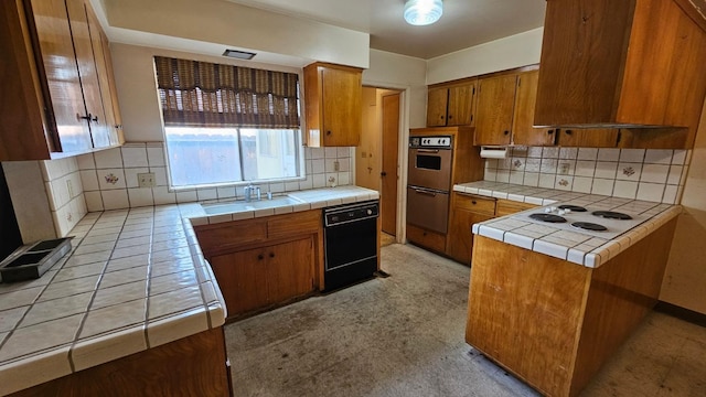 kitchen featuring tile counters, white electric cooktop, black dishwasher, and a sink