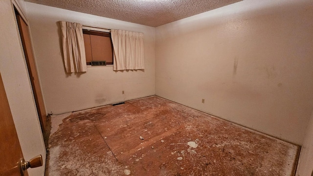 empty room with visible vents and a textured ceiling