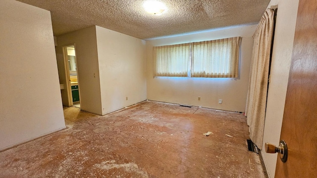 empty room with a textured ceiling