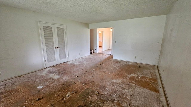 unfurnished bedroom featuring a closet and a textured ceiling