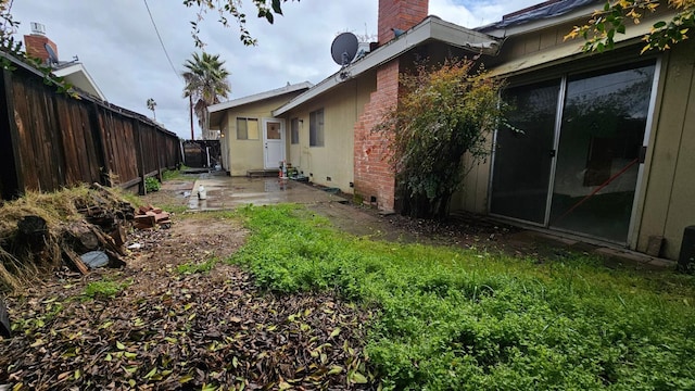 view of yard with entry steps, a patio area, and fence