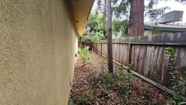 view of yard featuring central air condition unit and a fenced backyard