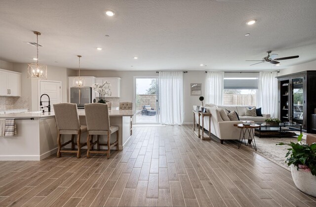 1093 Traverse Dr S, Madera, CA 93636 - living area featuring recessed lighting, baseboards, a ceiling fan, and light wood finished floors