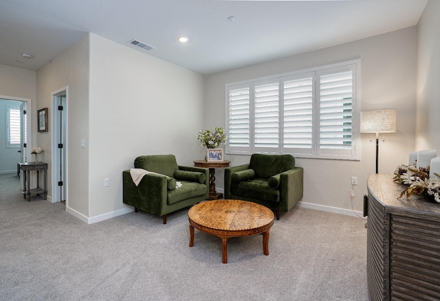 living area with recessed lighting, visible vents, light carpet, and baseboards