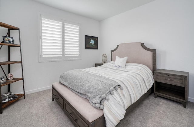 bedroom featuring baseboards and light carpet