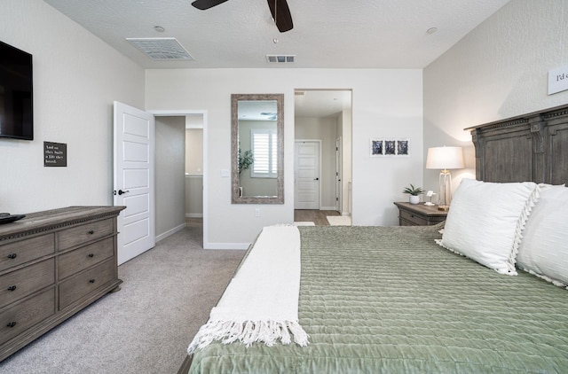 bedroom featuring visible vents, light colored carpet, baseboards, and ceiling fan