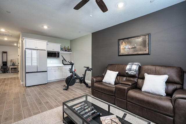 living room featuring visible vents, a ceiling fan, recessed lighting, baseboards, and wood tiled floor