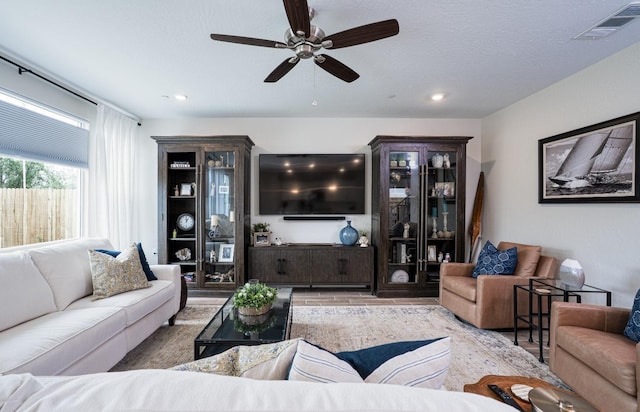 living area featuring recessed lighting, visible vents, wood finished floors, and a ceiling fan