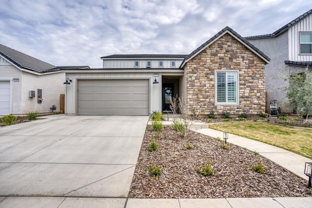 view of front of home with stone siding, concrete driveway, and an attached garage