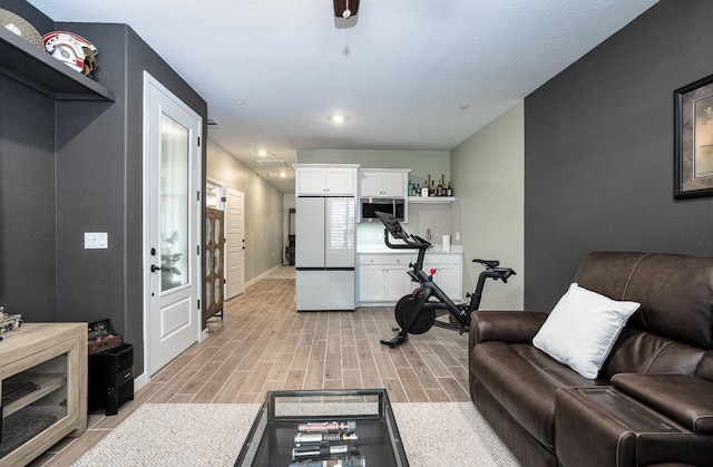 living room featuring baseboards and wood tiled floor