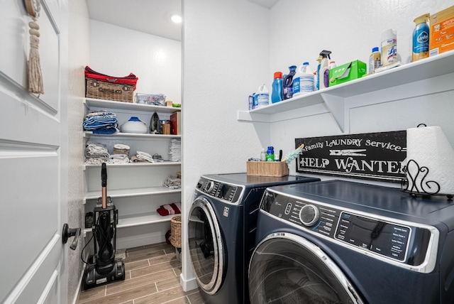 clothes washing area with laundry area, washer and dryer, and wood tiled floor