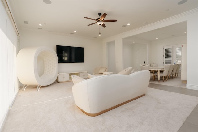 living area featuring light carpet, recessed lighting, ceiling fan, and ornamental molding