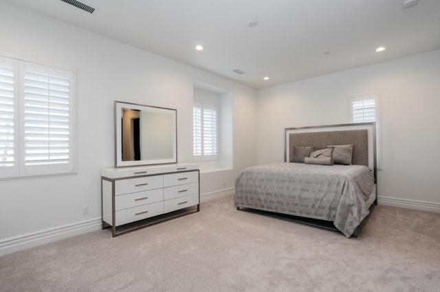 bedroom with baseboards, recessed lighting, visible vents, and light carpet