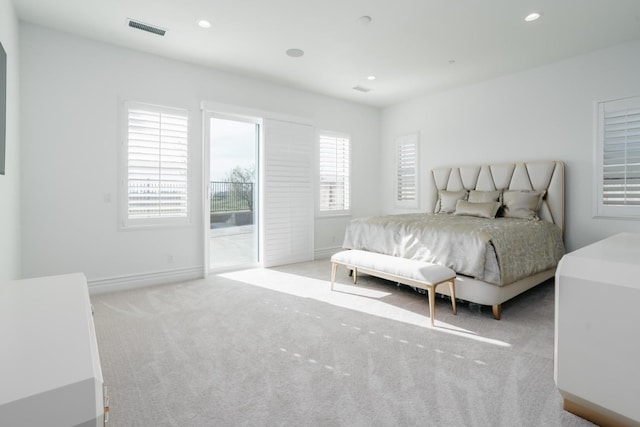 carpeted bedroom featuring recessed lighting, visible vents, baseboards, and access to exterior