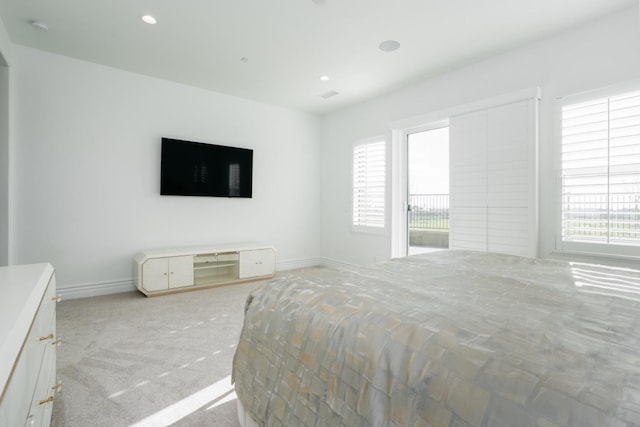 carpeted bedroom featuring recessed lighting and baseboards