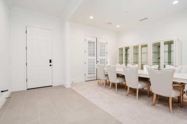 tiled dining room with recessed lighting, baseboards, carpet floors, and crown molding
