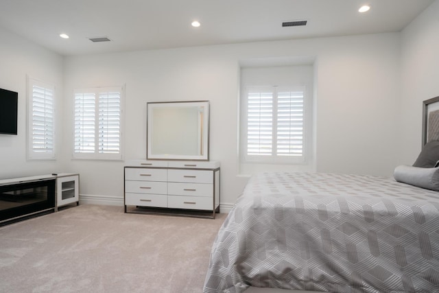 bedroom with recessed lighting, visible vents, and light colored carpet