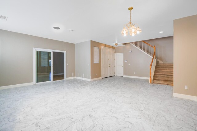 unfurnished living room featuring visible vents, baseboards, stairs, a notable chandelier, and marble finish floor