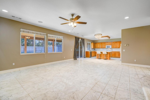 unfurnished living room with baseboards, visible vents, recessed lighting, ceiling fan, and marble finish floor