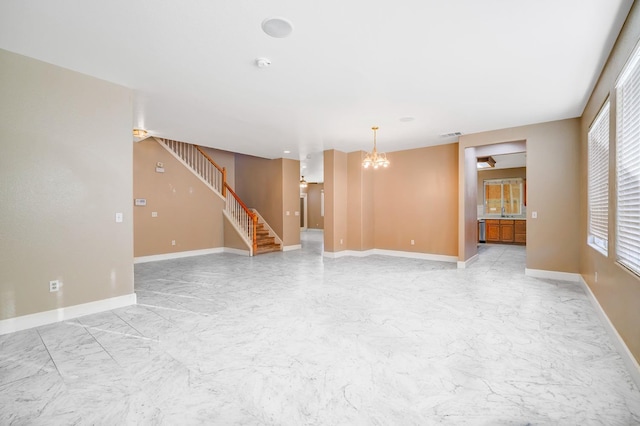 unfurnished living room with stairway, baseboards, a notable chandelier, and marble finish floor