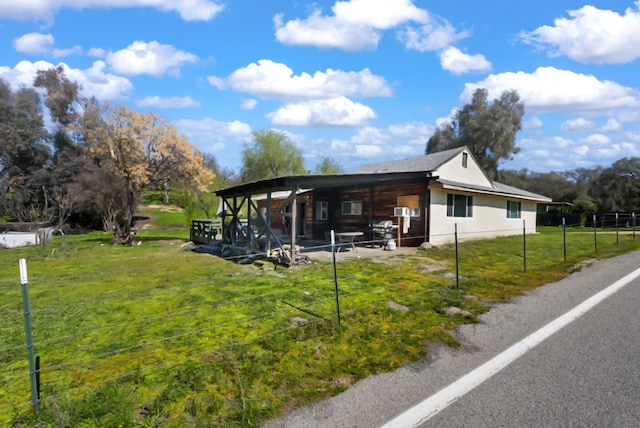 exterior space with a lawn and fence