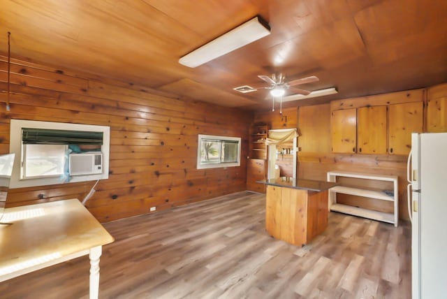 kitchen with visible vents, light wood-style flooring, a ceiling fan, freestanding refrigerator, and wooden ceiling