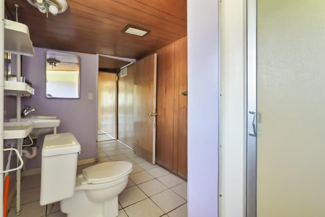 bathroom with tile patterned flooring, wooden ceiling, and toilet